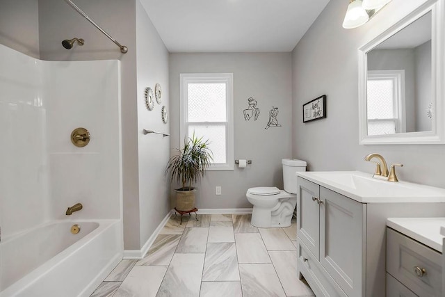920 S Washington St, Independence, MO 64050 - bathroom featuring vanity, toilet, marble finish flooring, tub / shower combination, and baseboards