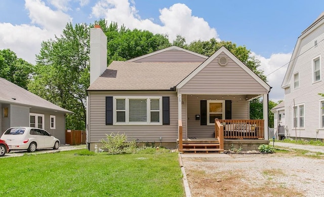 920 S Washington St, Independence, MO 64050 - bungalow with covered porch, a front yard, and a chimney
