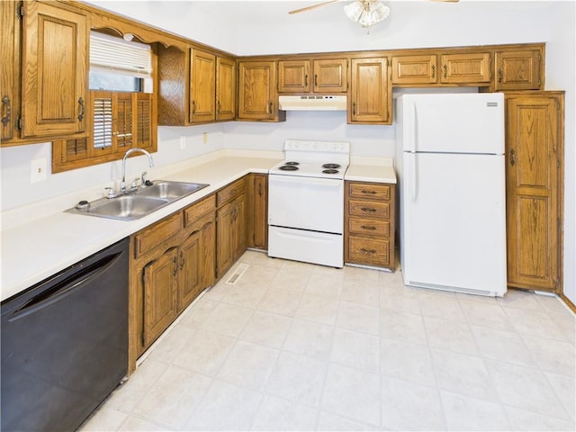 240 SE 121st Rd, Warrensburg, MO 64093 - kitchen featuring white appliances, a sink, under cabinet range hood, and brown cabinetry