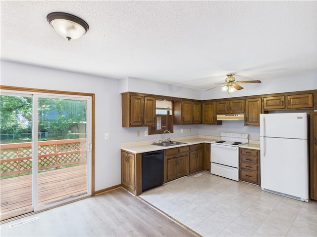 240 SE 121st Rd, Warrensburg, MO 64093 - kitchen featuring white appliances, under cabinet range hood, a sink, plenty of natural light, and a textured ceiling
