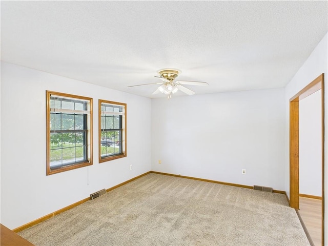 240 SE 121st Rd, Warrensburg, MO 64093 - empty room featuring ceiling fan, light carpet, baseboards, and a textured ceiling