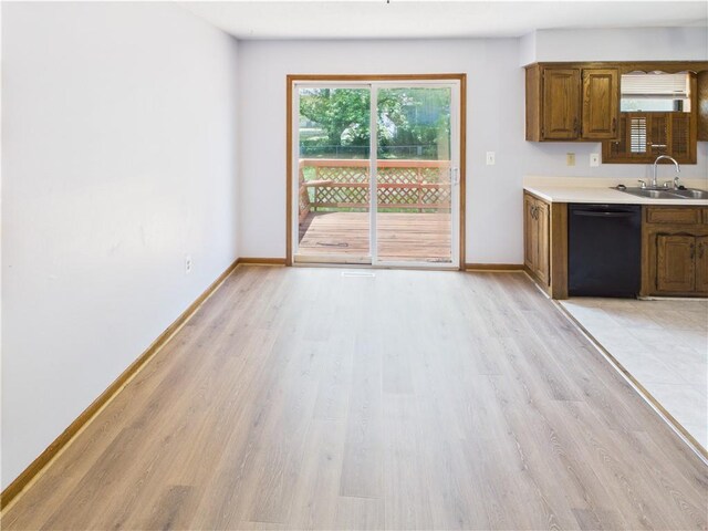 240 SE 121st Rd, Warrensburg, MO 64093 - kitchen featuring dishwasher, a sink, light wood finished floors, light countertops, and baseboards