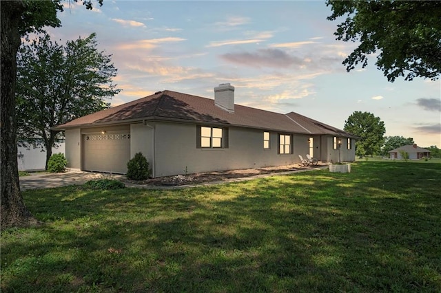 22617 155th St, Basehor, KS 66007 - view of property exterior featuring a chimney, an attached garage, a yard, and driveway