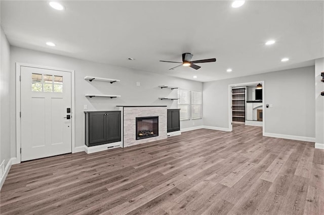 22617 155th St, Basehor, KS 66007 - unfurnished living room with a fireplace, ceiling fan, wood finished floors, and recessed lighting