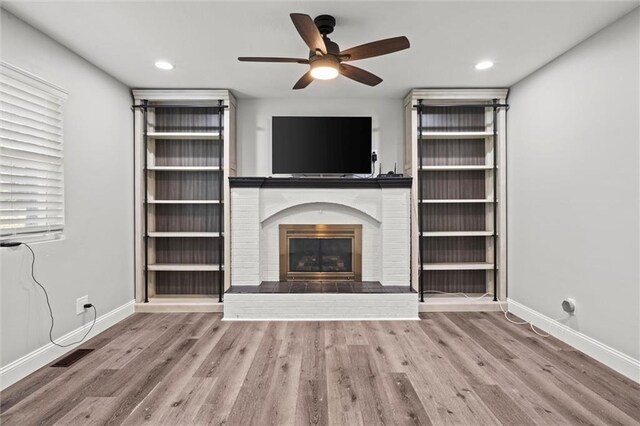 22617 155th St, Basehor, KS 66007 - unfurnished living room featuring ceiling fan, wood finished floors, a fireplace, and recessed lighting