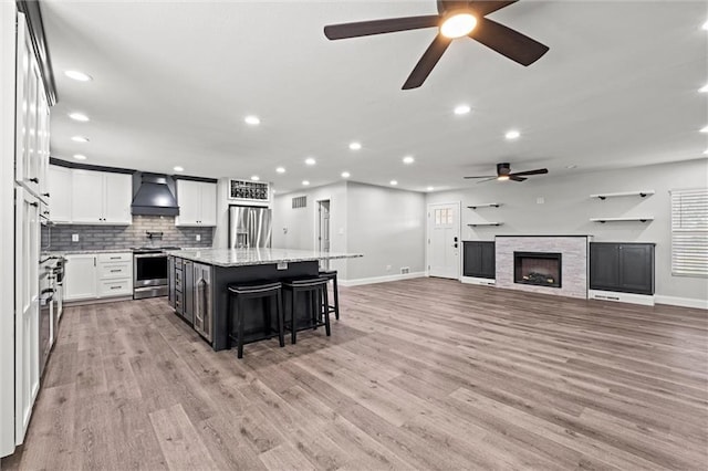 22617 155th St, Basehor, KS 66007 - kitchen featuring stainless steel appliances, custom range hood, ceiling fan, a kitchen island, and recessed lighting