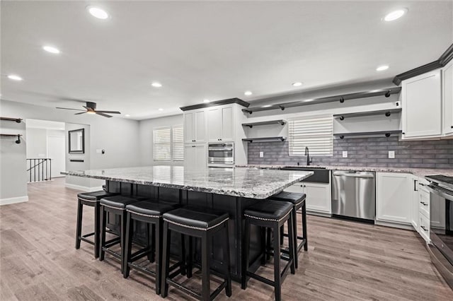 22617 155th St, Basehor, KS 66007 - kitchen with open shelves, stainless steel appliances, tasteful backsplash, plenty of natural light, and recessed lighting