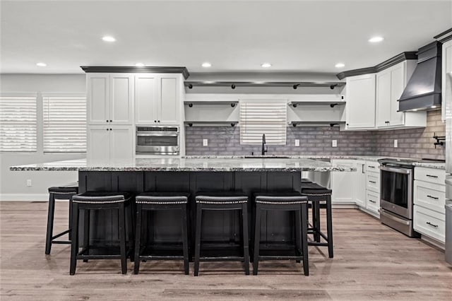 22617 155th St, Basehor, KS 66007 - kitchen with appliances with stainless steel finishes, open shelves, premium range hood, tasteful backsplash, and recessed lighting