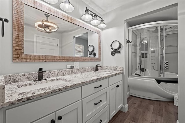 22617 155th St, Basehor, KS 66007 - full bathroom with wood finished floors, double vanity, and shower / bath combination with glass door