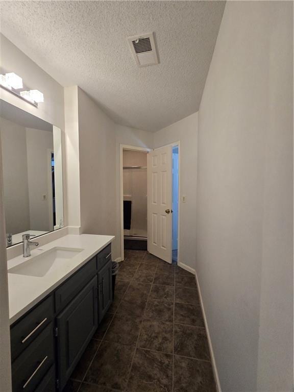 13810 W 53rd St, Shawnee, KS 66216 - bathroom with vanity, baseboards, and a textured ceiling