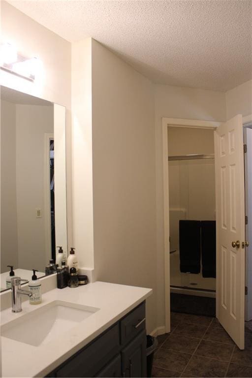 13810 W 53rd St, Shawnee, KS 66216 - full bath featuring vanity, a textured ceiling, tile patterned floors, and a shower