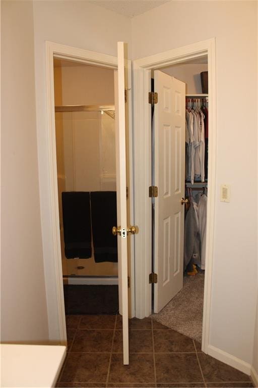 13810 W 53rd St, Shawnee, KS 66216 - bathroom featuring a shower with door, tile patterned floors, and a walk in closet