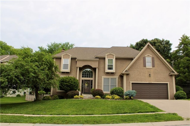 13810 W 53rd St, Shawnee, KS 66216 - traditional-style home featuring driveway, a front yard, a garage, and stucco siding