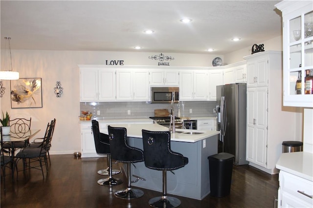 13810 W 53rd St, Shawnee, KS 66216 - kitchen with stainless steel appliances, light countertops, dark wood-style floors, white cabinetry, and backsplash