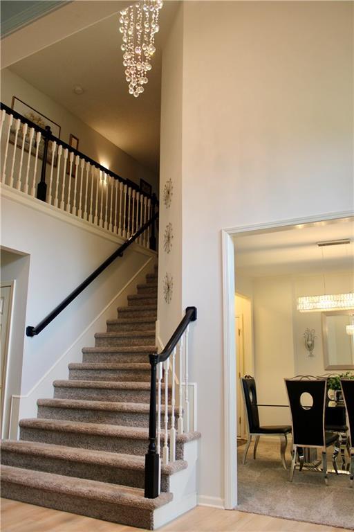 13810 W 53rd St, Shawnee, KS 66216 - staircase featuring wood finished floors