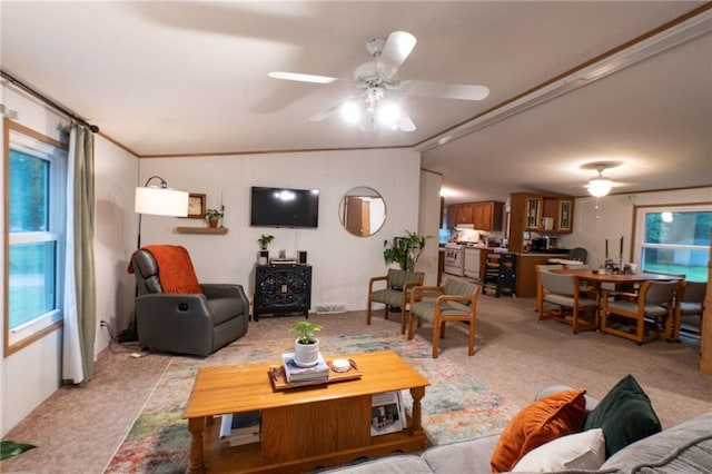 406 Cheyenne Ave, Coffeyville, KS 67337 - living room with ceiling fan, light colored carpet, and healthy amount of natural light