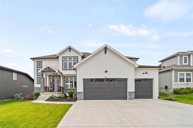1709 SW Hightown Dr, Lees Summit, MO 64082 - view of front of house featuring an attached garage, board and batten siding, stone siding, and driveway