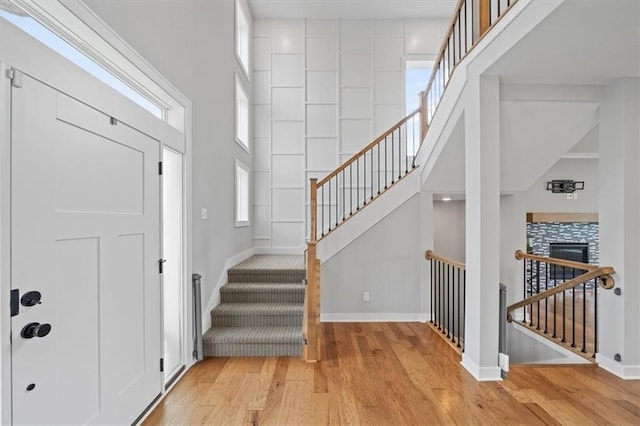 1709 SW Hightown Dr, Lees Summit, MO 64082 - entrance foyer featuring wood finished floors, a towering ceiling, and stairway