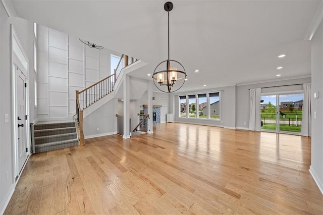1709 SW Hightown Dr, Lees Summit, MO 64082 - unfurnished living room with light wood-style floors, a chandelier, plenty of natural light, stairs, and recessed lighting