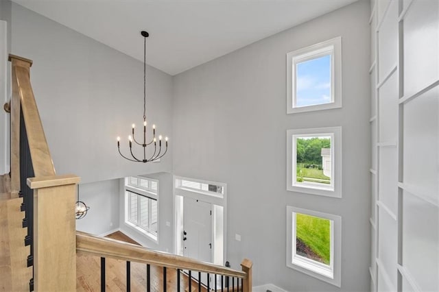 1709 SW Hightown Dr, Lees Summit, MO 64082 - staircase featuring a high ceiling, a chandelier, and wood finished floors