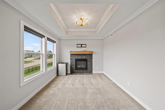 1709 SW Hightown Dr, Lees Summit, MO 64082 - unfurnished living room featuring a raised ceiling, crown molding, carpet flooring, a chandelier, and a fireplace