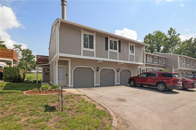 14107 W 88th St, Lenexa, KS 66215 - townhome / multi-family property featuring driveway, a garage, and a front yard