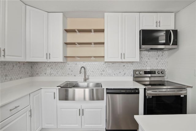 14107 W 88th St, Lenexa, KS 66215 - kitchen featuring appliances with stainless steel finishes, open shelves, white cabinetry, light countertops, and decorative backsplash