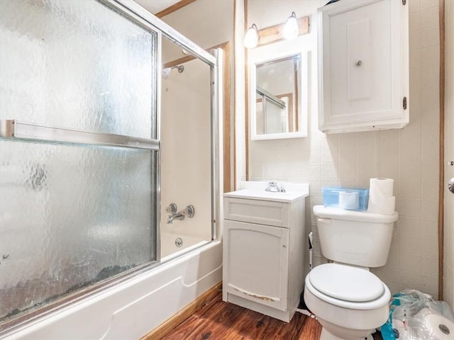 2517 Faraon St, Saint Joseph, MO 64501 - full bath with wood finished floors, toilet, combined bath / shower with glass door, and vanity