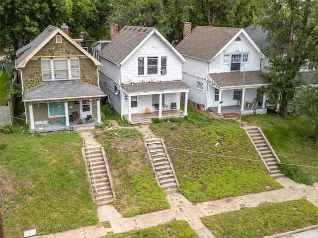 2517 Faraon St, Saint Joseph, MO 64501 - view of front of home with a porch, stairs, and a front lawn