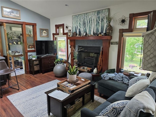 8050 SE Benner Lake Rd, Dearborn, MO 64439 - living area with wood finished floors, vaulted ceiling, and a glass covered fireplace