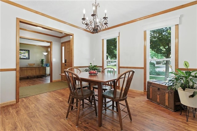 15206 W 85th St, Lenexa, KS 66219 - dining area featuring wood finished floors, a chandelier, and crown molding