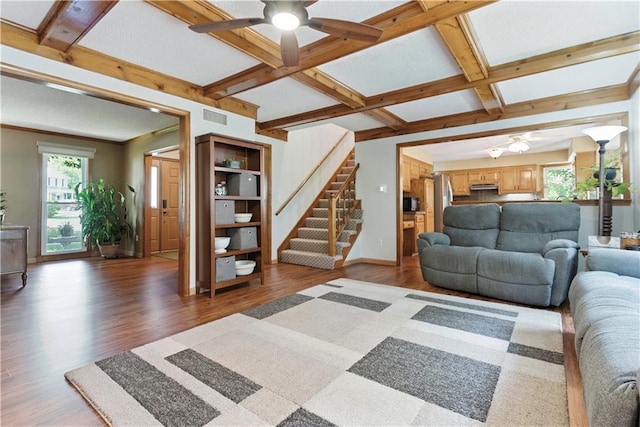 15206 W 85th St, Lenexa, KS 66219 - living room featuring a ceiling fan, wood finished floors, coffered ceiling, stairway, and beam ceiling