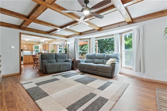 15206 W 85th St, Lenexa, KS 66219 - living area with ceiling fan, healthy amount of natural light, coffered ceiling, and beamed ceiling