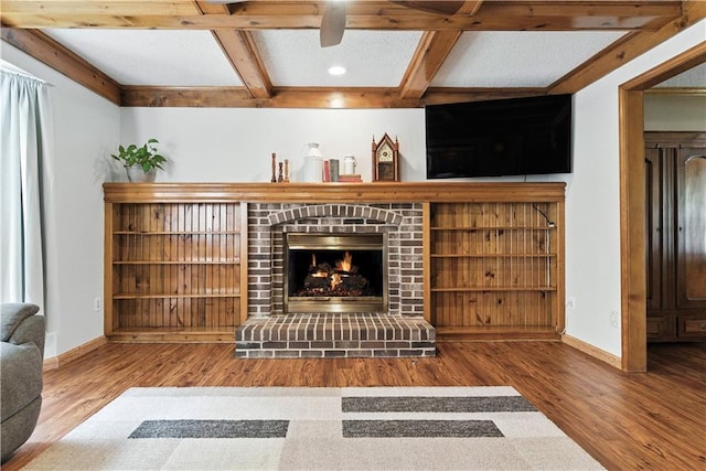 15206 W 85th St, Lenexa, KS 66219 - living room featuring wood finished floors, coffered ceiling, a fireplace, and beamed ceiling
