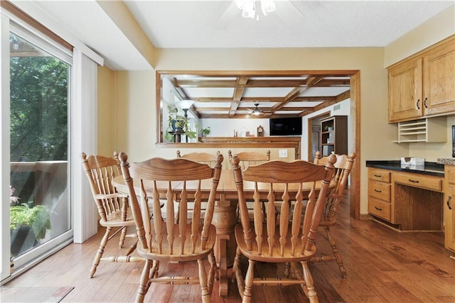 15206 W 85th St, Lenexa, KS 66219 - dining area featuring a ceiling fan, coffered ceiling, light wood-type flooring, and beamed ceiling