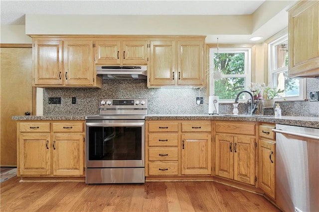 15206 W 85th St, Lenexa, KS 66219 - kitchen with appliances with stainless steel finishes, under cabinet range hood, light wood-type flooring, and decorative backsplash