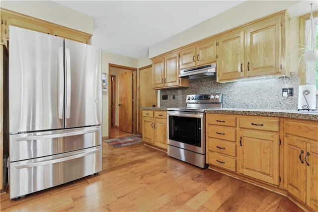 15206 W 85th St, Lenexa, KS 66219 - kitchen featuring appliances with stainless steel finishes, under cabinet range hood, light wood-style floors, decorative backsplash, and light brown cabinetry