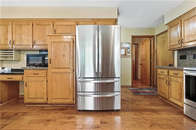15206 W 85th St, Lenexa, KS 66219 - kitchen with stainless steel appliances, dark countertops, dark wood-style flooring, backsplash, and a textured ceiling