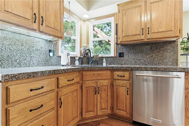 15206 W 85th St, Lenexa, KS 66219 - kitchen featuring stainless steel dishwasher, tasteful backsplash, wood finished floors, and dark stone countertops