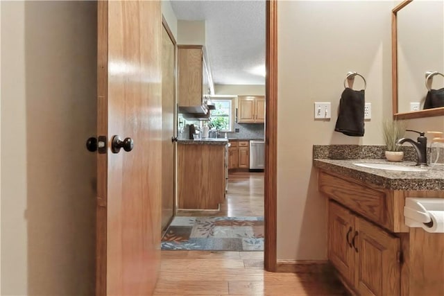 15206 W 85th St, Lenexa, KS 66219 - bathroom featuring wood finished floors, vanity, and a textured ceiling