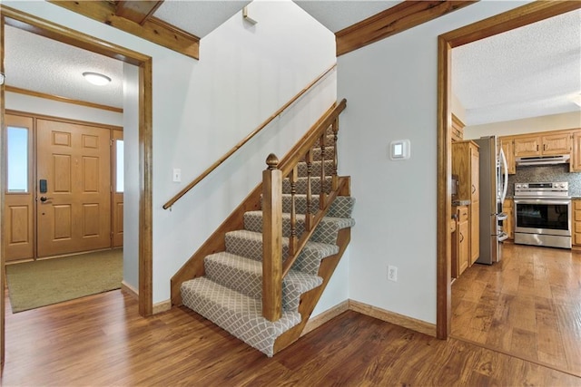 15206 W 85th St, Lenexa, KS 66219 - stairway featuring wood finished floors and a textured ceiling