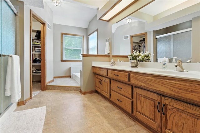 15206 W 85th St, Lenexa, KS 66219 - full bathroom with a spacious closet, a stall shower, double vanity, a bath, and vaulted ceiling