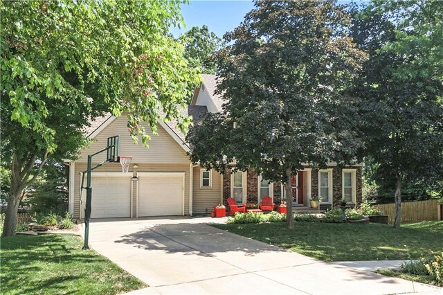 15206 W 85th St, Lenexa, KS 66219 - obstructed view of property with an attached garage and driveway