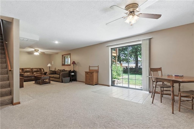 15206 W 85th St, Lenexa, KS 66219 - carpeted living area with a ceiling fan, stairs, and a textured ceiling