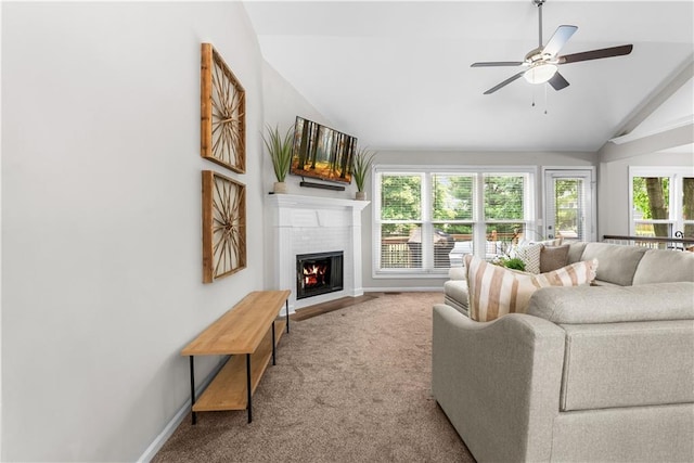 1021 NE Woodbury Ln, Lees Summit, MO 64086 - living room featuring vaulted ceiling, a fireplace, baseboards, ceiling fan, and carpet flooring