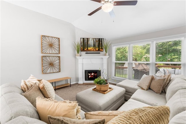 1021 NE Woodbury Ln, Lees Summit, MO 64086 - carpeted living room featuring lofted ceiling, ceiling fan, a lit fireplace, and baseboards