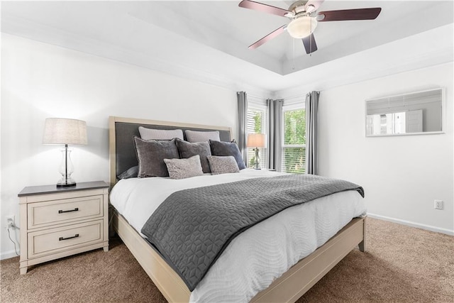 1021 NE Woodbury Ln, Lees Summit, MO 64086 - bedroom featuring carpet flooring, baseboards, a ceiling fan, and a tray ceiling