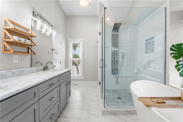 1021 NE Woodbury Ln, Lees Summit, MO 64086 - full bath with marble finish floors, a soaking tub, a stall shower, double vanity, and baseboards