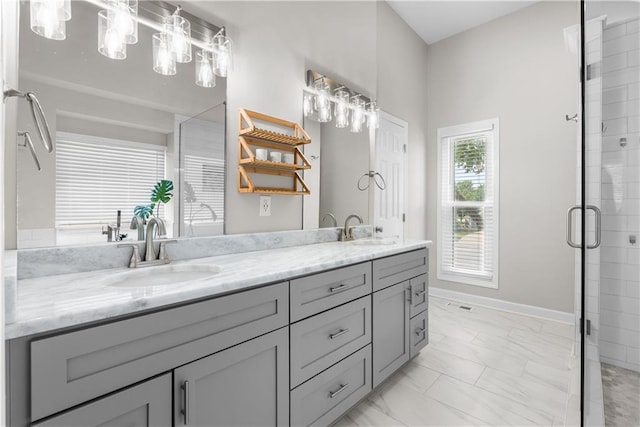 1021 NE Woodbury Ln, Lees Summit, MO 64086 - bathroom with double vanity, marble look tile flooring, a shower stall, and baseboards