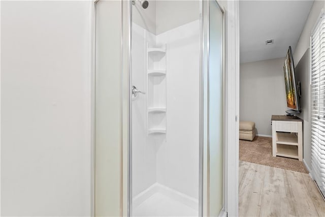 1021 NE Woodbury Ln, Lees Summit, MO 64086 - bathroom with a stall shower and wood finished floors